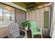 Relaxing patio seating area with potted plant, outdoor decor, and view to living area at 5783 Peregrine Ave # C07, Orlando, FL 32819