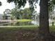 Picturesque pond view with a fountain, bridge, and lush greenery, creating a relaxing and scenic environment at 5783 Peregrine Ave # C07, Orlando, FL 32819