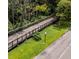 Aerial view featuring the community's wooden walking bridge surrounded by beautiful green foliage at 120 Hibiscus Woods Ct # 8D, Deltona, FL 32725