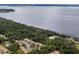 Aerial view showcasing the beautiful waterfront property with lush trees and residential buildings at 120 Hibiscus Woods Ct # 8D, Deltona, FL 32725