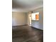 Spacious living room boasts modern wood-look flooring, connecting seamlessly to the kitchen at 120 Hibiscus Woods Ct # 8D, Deltona, FL 32725