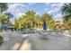 A refreshing outdoor pool with surrounding lounge chairs, tables, and umbrellas for relaxation at 120 Hibiscus Woods Ct # 8D, Deltona, FL 32725
