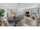 Modern dining area with a round table and six chairs, adjacent to kitchen at 344 Belmond Dr, Debary, FL 32713