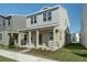 Two-story house with light beige siding, stone accents, and a covered porch at 344 Belmond Dr, Debary, FL 32713