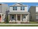 Two-story house with light beige siding, stone accents, and a covered porch at 344 Belmond Dr, Debary, FL 32713