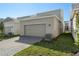 Attached garage with light beige door and paver driveway at 344 Belmond Dr, Debary, FL 32713