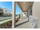 Covered front porch with stone accents and light beige columns at 344 Belmond Dr, Debary, FL 32713