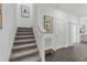 Modern staircase with gray carpeting and artwork on the wall at 344 Belmond Dr, Debary, FL 32713