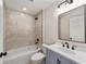 Bathroom featuring a tub shower with tiled surround, stylish vanity and neutral color palette at 3590 Sw 150Th Ct, Ocala, FL 34481