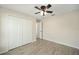 Cozy bedroom features wood-look tile flooring, a ceiling fan, and closet storage space at 3590 Sw 150Th Ct, Ocala, FL 34481