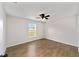 Spacious bedroom showcasing wood-look tile flooring, a window view, and neutral wall paint at 3590 Sw 150Th Ct, Ocala, FL 34481