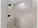 Modern shower with marble-patterned tile, offering a sleek and luxurious bathing experience at 3590 Sw 150Th Ct, Ocala, FL 34481