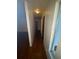 Well-lit hallway with hardwood floors, connecting different sections of the home at 4663 Montauk St, Orlando, FL 32808