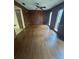 Wood-paneled living room filled with natural light and well maintained hardwood flooring at 4663 Montauk St, Orlando, FL 32808