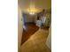 Bright living room with hardwood and tile flooring complemented by a stylish chandelier at 4663 Montauk St, Orlando, FL 32808