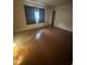 Inviting living room featuring sleek, continuous hardwood flooring, and soft, natural lighting at 4663 Montauk St, Orlando, FL 32808