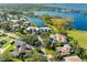 Stunning aerial view of lakeside homes with mature trees and landscaping along the shore at 8984 Houston Pl # 103, Orlando, FL 32819