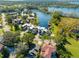 Aerial view of a residential area featuring stunning lakeside homes and mature trees at 8984 Houston Pl # 103, Orlando, FL 32819