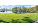 Picturesque lakeside view with boat docks, a lush green lawn, and serene water features at 8984 Houston Pl # 103, Orlando, FL 32819