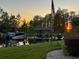 Scenic sunset view of a private dock with boat lifts and lush green landscaping at 8984 Houston Pl # 103, Orlando, FL 32819