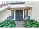 Inviting front entrance with a charming doorway, a chair, and lush greenery at 8984 Houston Pl # 103, Orlando, FL 32819