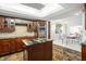 Beautiful kitchen featuring stainless steel appliances, a center island, and custom wood cabinetry at 8984 Houston Pl # 103, Orlando, FL 32819