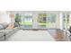 Bright living room with plush carpeting and large sliding glass doors with serene views at 8984 Houston Pl # 103, Orlando, FL 32819