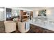 Elegant dining and sitting area with custom cabinetry, stylish furniture, and water view access at 8984 Houston Pl # 103, Orlando, FL 32819