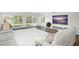 Inviting living area featuring comfortable seating and scenic water views through shuttered doors at 8984 Houston Pl # 103, Orlando, FL 32819