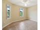 Well-lit bedroom with tile floors and two windows offering natural light at 2584 Dividing Creek Path, The Villages, FL 32162