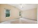 Bright bedroom with tile flooring, ceiling fan, and large windows at 2584 Dividing Creek Path, The Villages, FL 32162