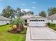 One-story home with white garage door and landscaped front yard at 2584 Dividing Creek Path, The Villages, FL 32162