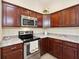 Modern kitchen with dark wood cabinets and granite countertops at 2584 Dividing Creek Path, The Villages, FL 32162