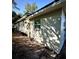 Side view of a single-story home features horizontal siding and modern windows at 709 N Lincoln Ave, Lakeland, FL 33815