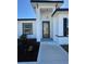 The home's welcoming entrance boasts a unique wood door and updated landscaping at 6208 Sw 129Th St, Ocala, FL 34473