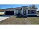 Charming single Gathering home showcasing dark trim and a modern front door, with new landscaping at 6208 Sw 129Th St, Ocala, FL 34473