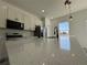 Modern kitchen island with granite countertops, stainless steel sink, black faucet, and pendant lighting above at 6208 Sw 129Th St, Ocala, FL 34473
