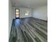 Well-lit living room with modern hard surface flooring and a view of the home's front entrance at 6208 Sw 129Th St, Ocala, FL 34473