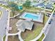 Overhead view of community pool and recreation area, featuring lounge chairs and surrounding neighborhood homes at 1352 Silo Dr, St Cloud, FL 34771