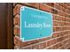 Carrington Park laundry room sign attached to a brick wall at 476 Banyon Tree Cir # 104, Maitland, FL 32751