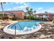 Sparkling community pool surrounded by brick buildings and lush landscaping at 476 Banyon Tree Cir # 104, Maitland, FL 32751