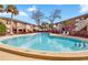 Inviting community pool with sun loungers offers relaxation and recreation at 476 Banyon Tree Cir # 104, Maitland, FL 32751