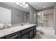 Bathroom featuring a single vanity with dark wood cabinets, and a shower with glass doors at 772 Stephens Pass Cv, Lake Mary, FL 32746