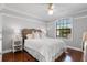 Bright bedroom with hardwood floors, neutral walls, a window, and a decorative headboard at 772 Stephens Pass Cv, Lake Mary, FL 32746