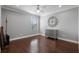 Bedroom featuring gray walls, ceiling fan, wood floors, and a decorative accent cabinet at 772 Stephens Pass Cv, Lake Mary, FL 32746