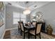 Formal dining room featuring modern chandelier, decorative mirror, and table set for six at 772 Stephens Pass Cv, Lake Mary, FL 32746