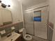 Functional bathroom featuring a shower with sliding glass doors, toilet, and sink with vanity at 919 Timor Ave, Orlando, FL 32804