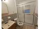 Bathroom with a shower with sliding glass doors, toilet, sink with vanity, and tiled walls at 919 Timor Ave, Orlando, FL 32804