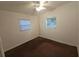 Neutral bedroom featuring two windows for natural light and neutral carpet at 919 Timor Ave, Orlando, FL 32804