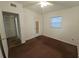 Simple bedroom featuring neutral carpet, ceiling fan, and a window for natural light at 919 Timor Ave, Orlando, FL 32804